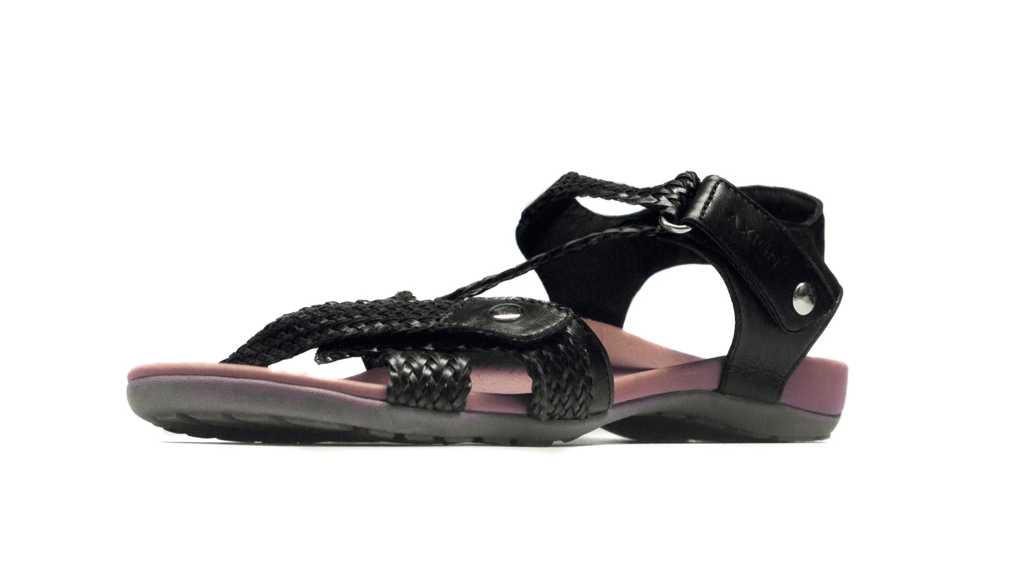 Black sandal with purple interior on a white background