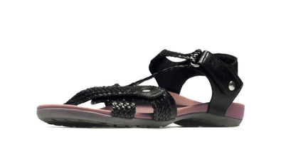 Black sandal with purple interior on a white background