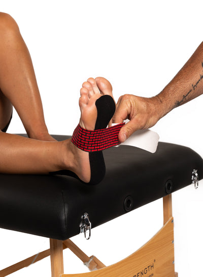 RockTape RHEON kinesiology tape applied to the foot and ankle
